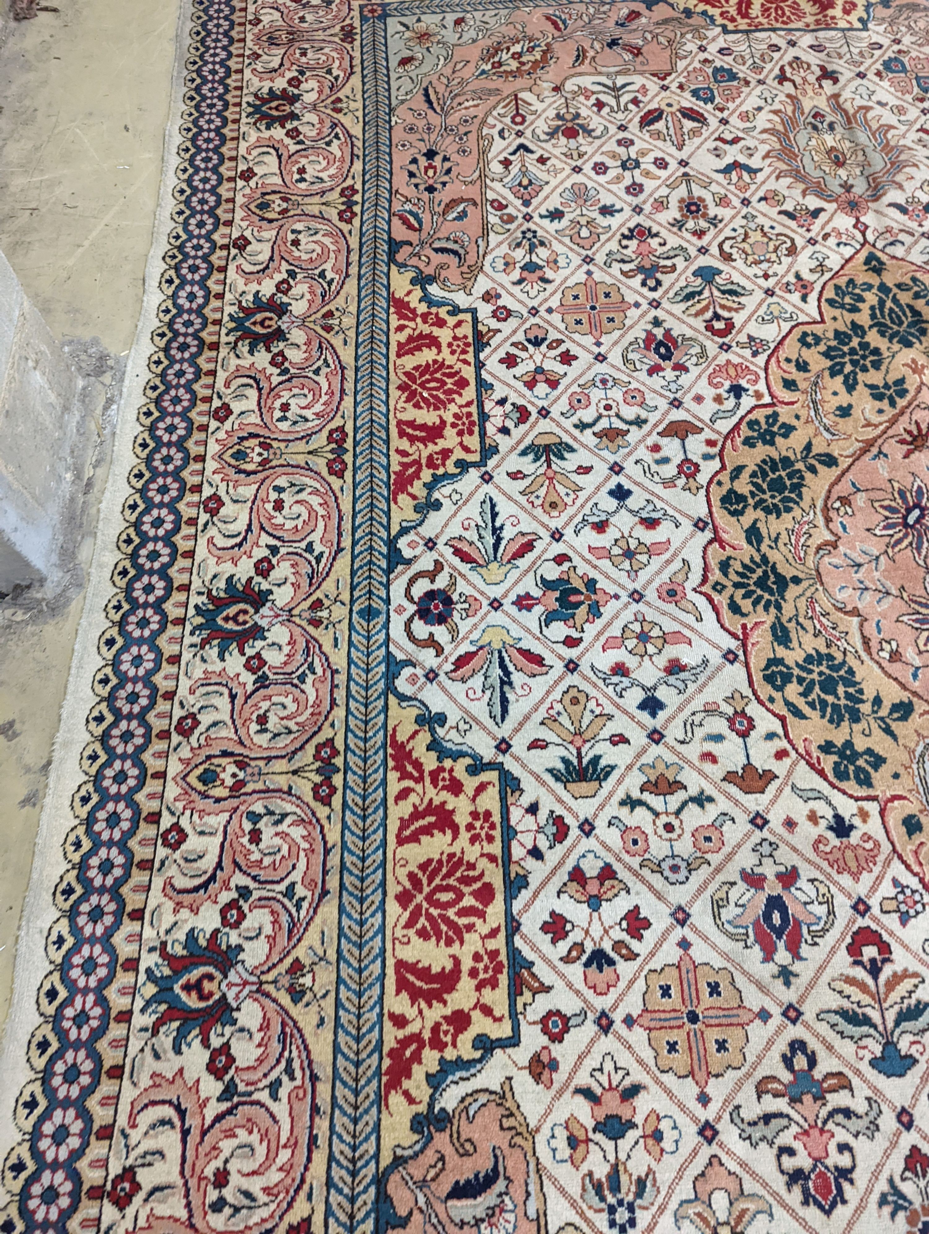 A Tabriz ivory ground carpet, 425 x 306cm